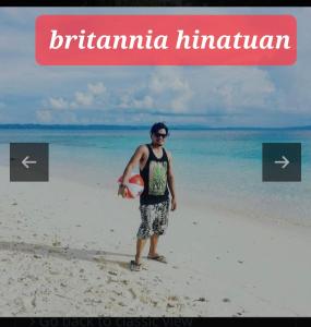 a man standing on the beach with a frisbee at BNJ Boarding House in Bislig