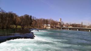 a river with a bridge and water rapids at Bravo Guest House in Bihać +24 photos