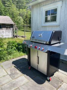 a barbecue grill sitting outside of a house at The Tannery House in Claryville