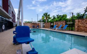 a blue chair sitting next to a swimming pool at SpringHill Suites by Marriott Baton Rouge Gonzales in Gonzales