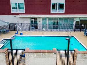 a large swimming pool in front of a building at SpringHill Suites by Marriott Baton Rouge Gonzales in Gonzales