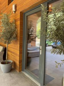 a glass door of a building with two potted plants at Gut Schlafen - Am Kogl in Hypolz