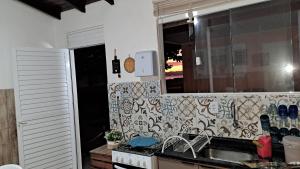 a kitchen with a sink and a counter top at Paraíso do Ribeirao da Ilha in Florianópolis