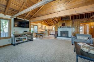 a living room with wooden ceilings and a fireplace at Delton Oasis Retreat with Lake Views and Deck! in Delton