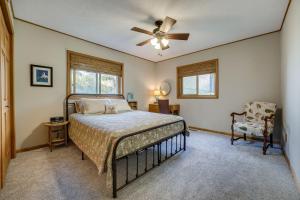 a bedroom with a bed and a ceiling fan at Delton Oasis Retreat with Lake Views and Deck! in Delton
