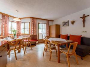 a living room with a table and chairs and a couch at Ferienhaus Dias in Kappl