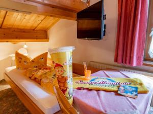 a bedroom with a table with a cup of coffee and a chair at Ferienhaus Dias in Kappl