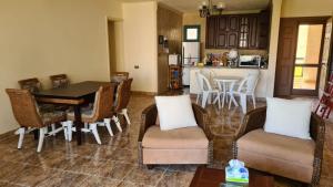 a kitchen and dining room with a table and chairs at Chalet in Mena 4 in Dawwār ‘Abd al ‘Aţī Abū ‘Ajūz