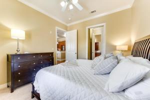 a bedroom with a large bed and a dresser at Lovely Baton Rouge Condo about 1 Mi to LSU in Baton Rouge