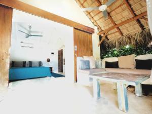 a living room with a couch and a table at Casa Picaflor in Las Terrenas