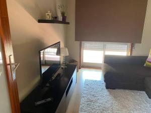 a living room with a mirror and a couch at S. Mamede House - Penafiel in Recezinhos