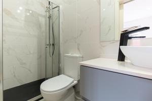 a bathroom with a toilet and a sink and a shower at Best House Center - with Garage in Porto