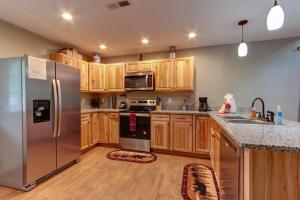a kitchen with a stainless steel refrigerator and wooden cabinets at 3 Master Bedrooms - Sleeps 10 - Location - Game Room - Hot Tub in Pigeon Forge
