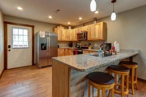 a kitchen with a counter top and a refrigerator at 3 Master Bedrooms - Sleeps 10 - Location - Game Room - Hot Tub in Pigeon Forge
