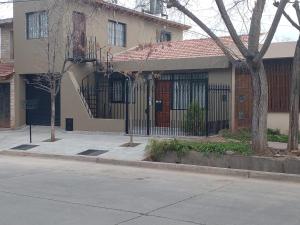a house with a wrought iron fence in front of it at DEPARTAMENTO PLANTA BAJA in Villa Nueva