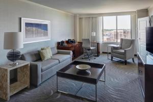 a living room with a couch and a table at Newport News Marriott at City Center in Newport News