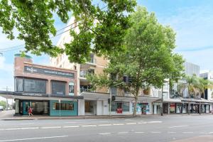 a street with a building on the corner of a street at 'The Crows Nest' Spacious Studio with Balcony in Sydney