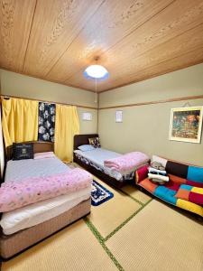 a bedroom with two beds and a couch at Shirahama in Miyazaki