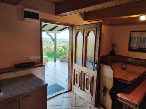 a kitchen with a door leading to a patio at Holiday house Panorama in Ozalj