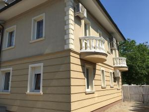 a building with a balcony on the side of it at Pelso Apartments in Siófok