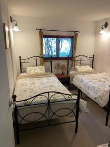 a bedroom with two beds and a window at Gallery HARA and guest house in Hara