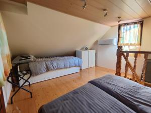 a bedroom with two beds and a refrigerator at Holiday house Panorama in Ozalj