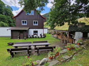 a house with a picnic table in front of it at Pension Piana in Pec pod Sněžkou