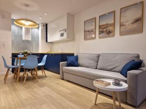 a living room with a couch and a table at Apricot Sea View Premium Apartment in Władysławowo