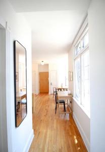 a living room with a table and a mirror at Brand New Stylish 1BDR In Heart Of Rittenhouse Sq. Hosted By StayRafa in Philadelphia