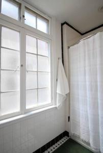 a bathroom with a shower curtain and a window at Brand New Stylish 1BDR In Heart Of Rittenhouse Sq. Hosted By StayRafa in Philadelphia
