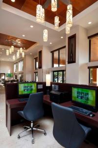 an office with two computer desks and two chairs at Courtyard by Marriott Boynton Beach in Boynton Beach