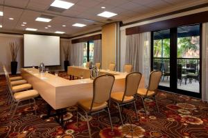 a conference room with a large table and chairs at Courtyard by Marriott Boynton Beach in Boynton Beach