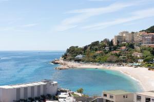 a view of a beach with buildings and the ocean at Riviera Marriott Hotel La Porte De Monaco in Cap d'Ail