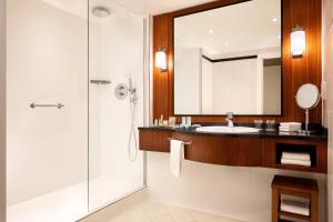 a bathroom with a sink and a shower at Riviera Marriott Hotel La Porte De Monaco in Cap d'Ail