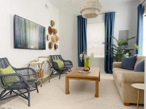 a living room with chairs and a couch and a table at New! Stylish 1900s Renovated Duplex Apartment Building Near Forsyth & River St in Savannah