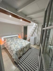 a bedroom with a bed and a staircase at Les chambre de amour in Urrugne