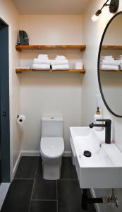 La salle de bains est pourvue de toilettes blanches et d'un lavabo. dans l'établissement The Inn at the Gate, à Skaneateles