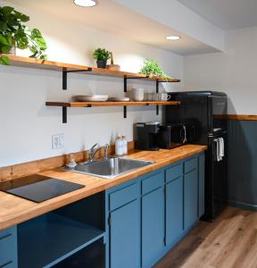 a kitchen with a sink and a black refrigerator at The Inn at the Gate in Skaneateles