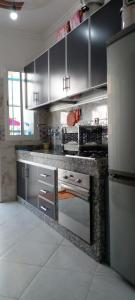 a kitchen with stainless steel cabinets and a stove at Al Hoceima Bades in Al Hoceïma