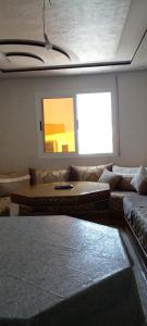 a living room with a couch and a window at Al Hoceima Bades in Al Hoceïma