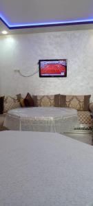 a room with a tv hanging on the wall at Al Hoceima Bades in Al Hoceïma