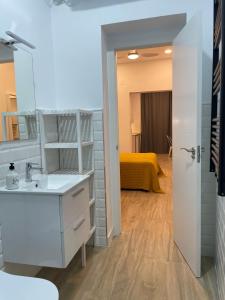 a bathroom with a sink and a room with a bed at Brand NEW Studio Centro, Atocha - Museums in Madrid