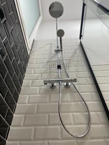a shower in a bathroom with a tile floor at Brand NEW Studio Centro, Atocha - Museums in Madrid