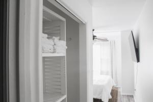a bathroom with a closet with white towels at 9 Palms Boutique Condos in Myrtle Beach +124 photos