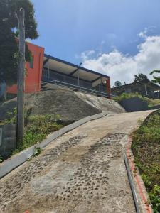 a dirt road leading up to a building at Single Room with Shared Kitchen and Living Room in Suva