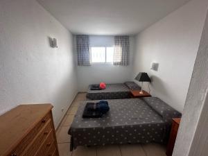 two beds in a small room with a window at Vista Hermosa in Portals Nous