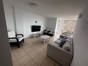 a living room with a couch and a tv at Vista Hermosa in Portals Nous