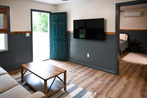a living room with a couch and a tv at The Gate in Skaneateles