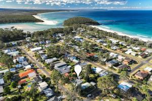 an aerial view of aussie houses next to the beach at Barney's Beach House Narrawallee in Narrawallee