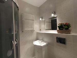 a bathroom with a sink and a mirror at Sopot Baltic in Sopot +68 photos